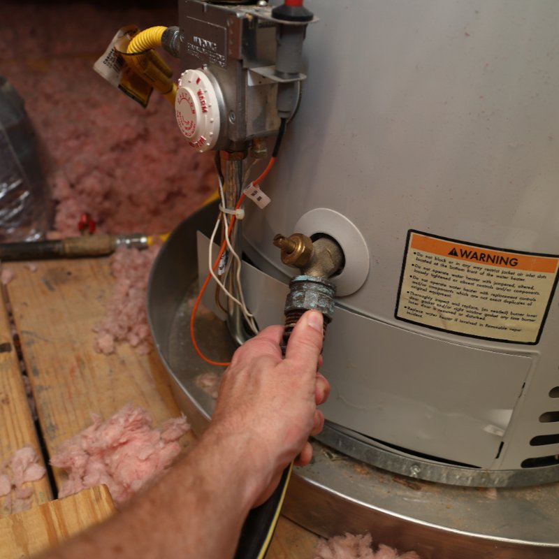 close-up of a hose being attached to a water heater