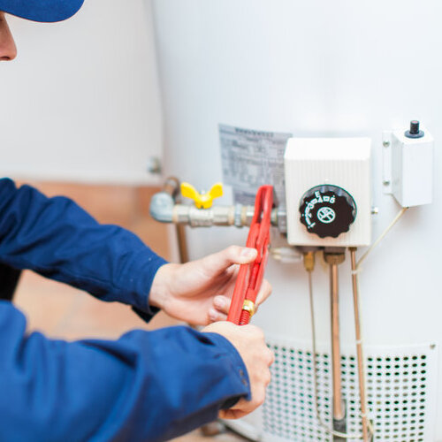 Plumber fixing a hot water heater.