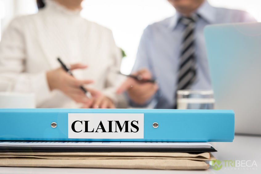 A Picture of a Claims Folder in Front of Two People.